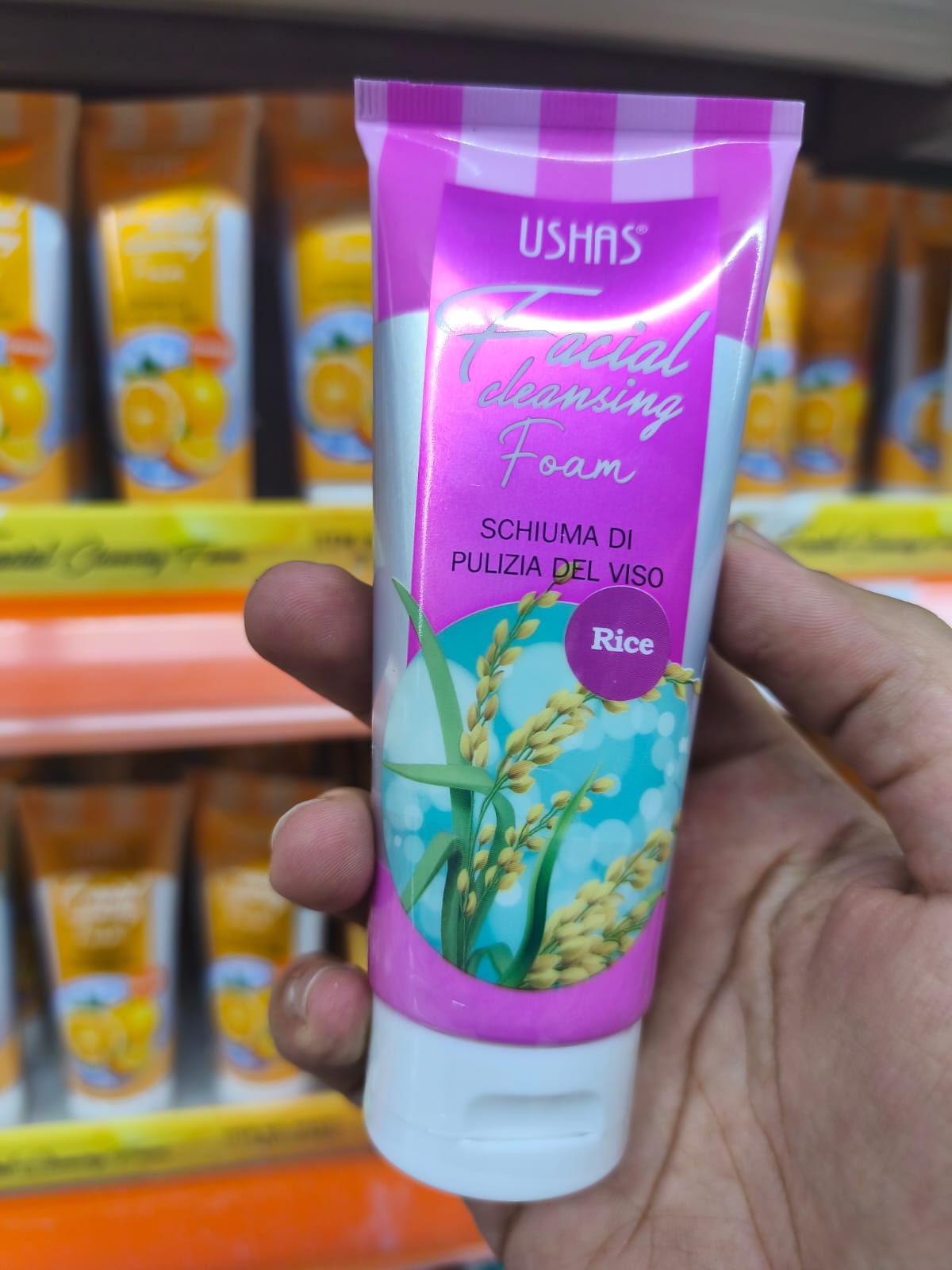 Ushas Facial Cleansing Foam with Rice in a hand, designed for effective facial cleansing.